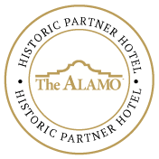 The image shows a circular logo for The Alamo, with 
