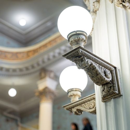 A grand, interior architectural scene with gilded railings, domed ceiling, and a marble staircase&mdash;elegant Baroque or neoclassical details in gold.