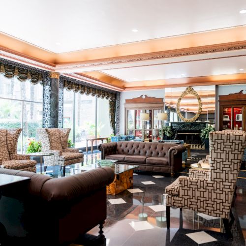 A stylish, sunlit caf&eacute; with wooden shelves, comfy chairs, plants, and a long counter, near large windows with a cozy, inviting vibe.